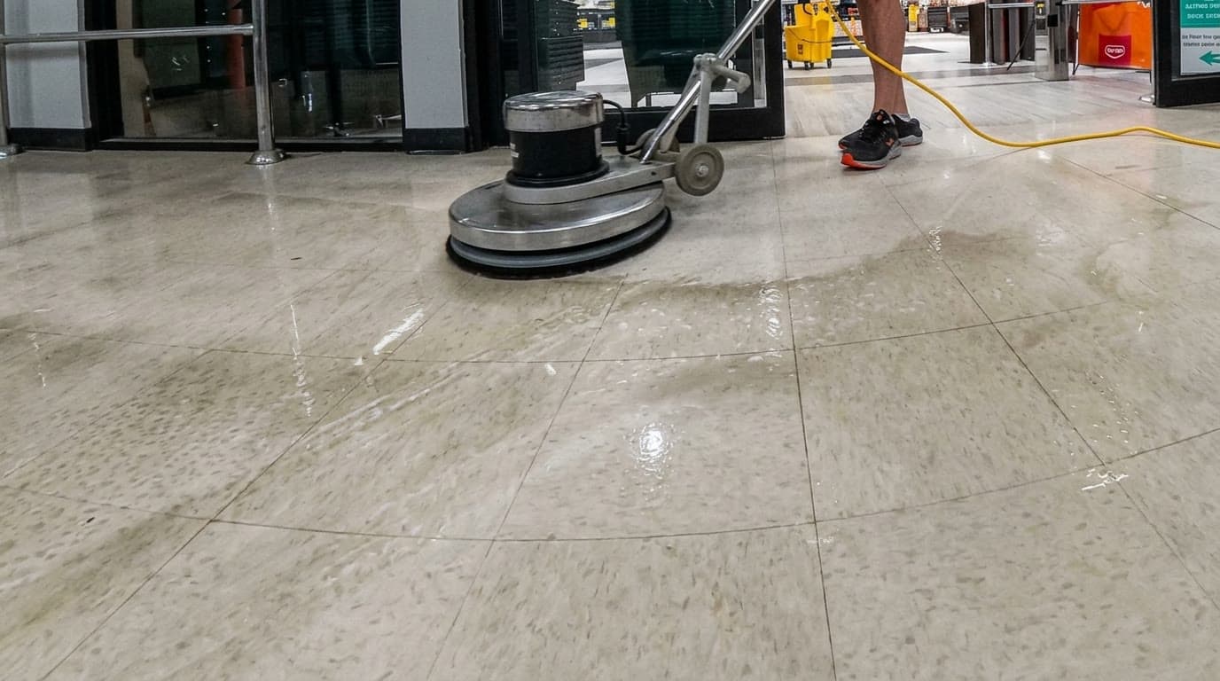 Floor buffer running over a glossy commercial floor