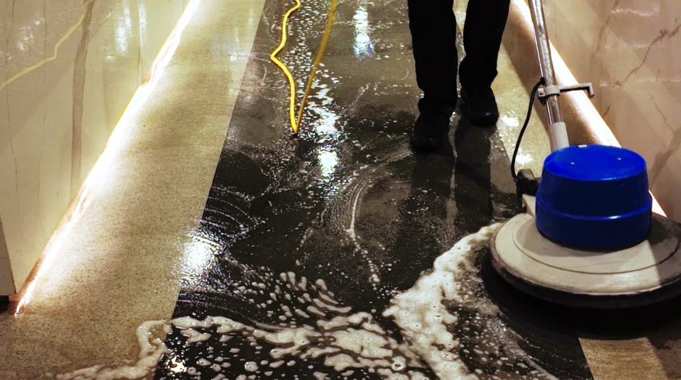 Concrete floor being machine scrubbed